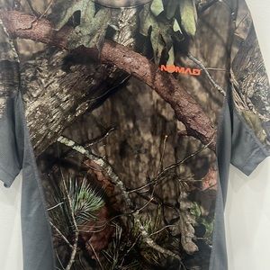 Men’s size Medium Nomad Camo short sleeve. 100% polyester material.